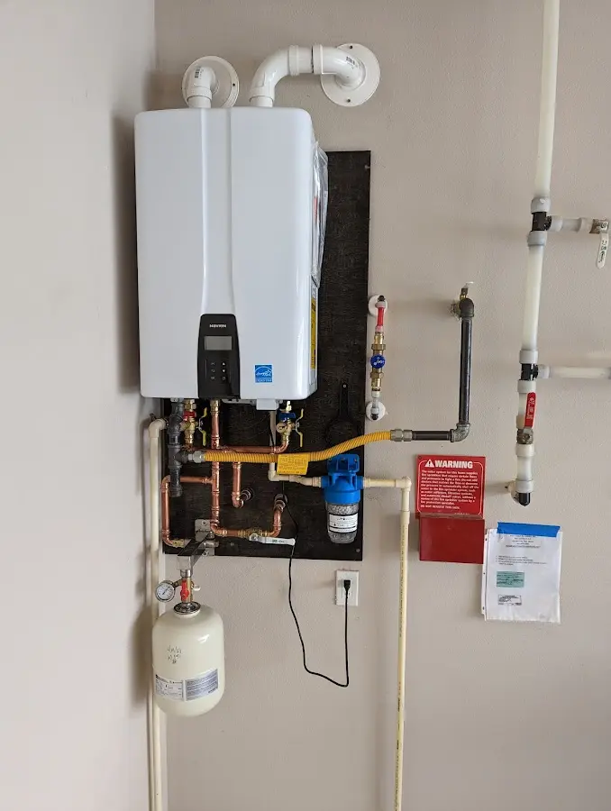 Professional plumber installing copper piping in a Farr West home